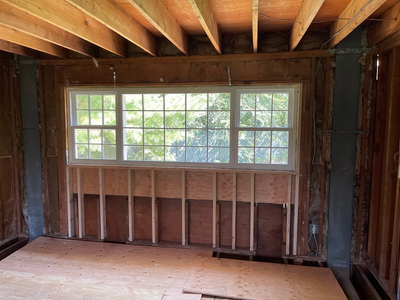 Spray foam insulates and seals around the window